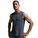 A muscular man wearing a dark gray sleeveless athletic tank top and matching gray athletic pants, posing against a light gray studio background.