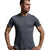 A man wearing a dark gray athletic t-shirt and matching gray shorts, standing against a light gray studio background.