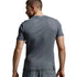 A man shown from the back wearing a dark gray athletic t-shirt and matching gray shorts against a light gray studio background.