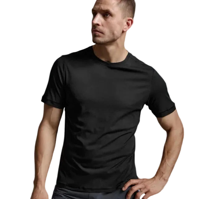 A man wearing a black short-sleeve athletic t-shirt and dark gray shorts, posing against a light gray studio background.