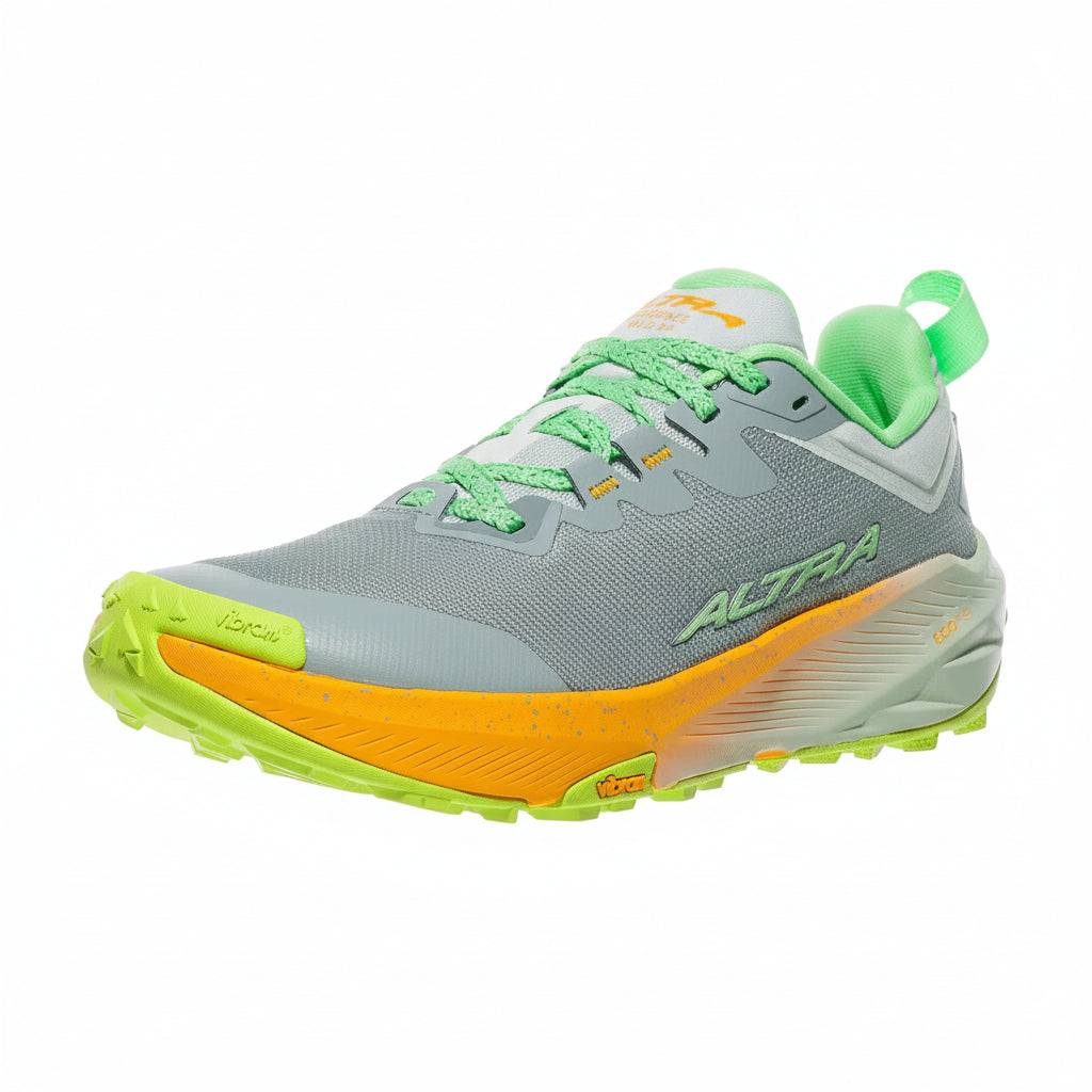 Gray and green running shoe with orange sole on a white background