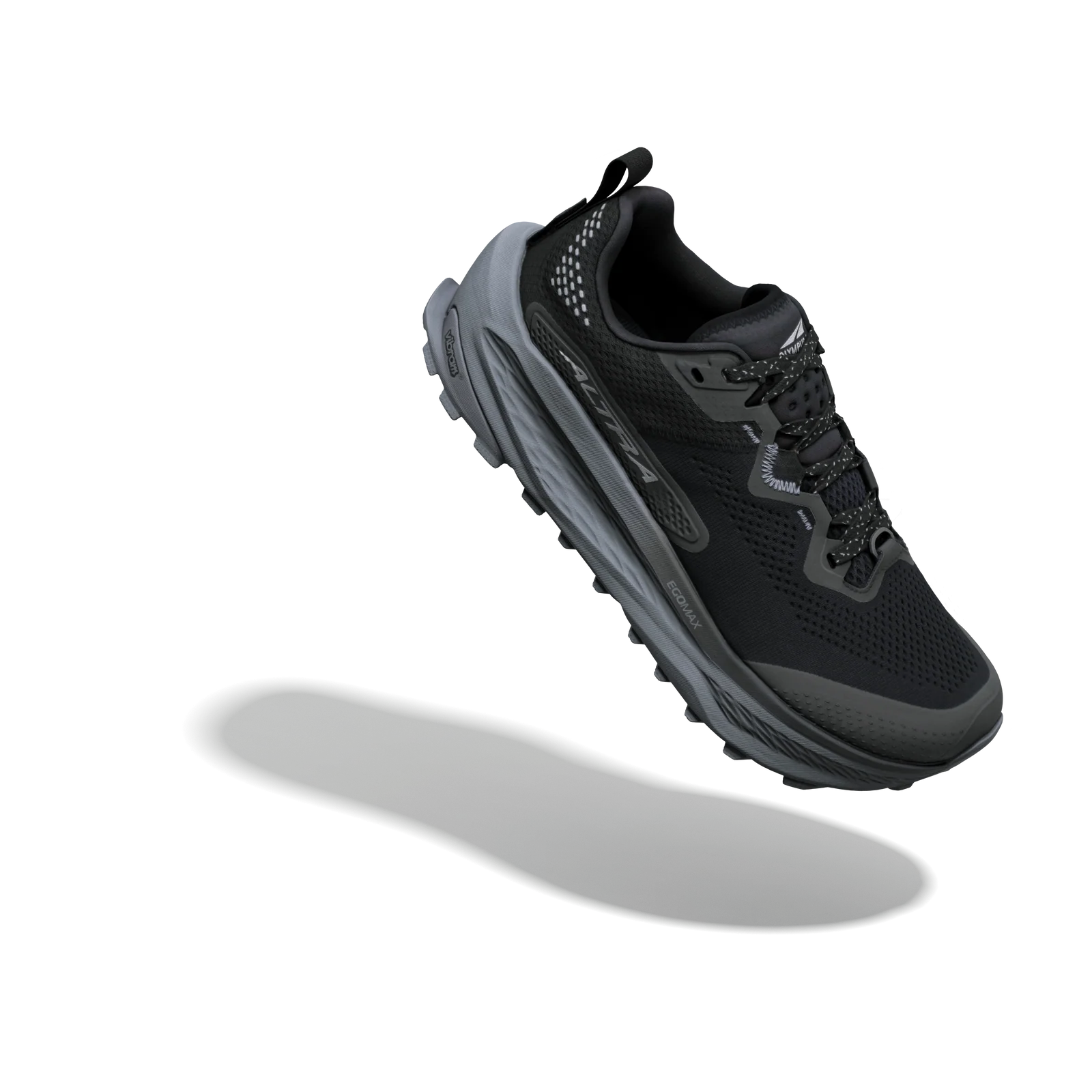 A black and dark gray athletic trail running shoe shown floating at an angle against a solid white background, with a soft gray shadow underneath.