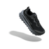 A black and dark gray athletic trail running shoe shown floating at an angle against a solid white background, with a soft gray shadow underneath.