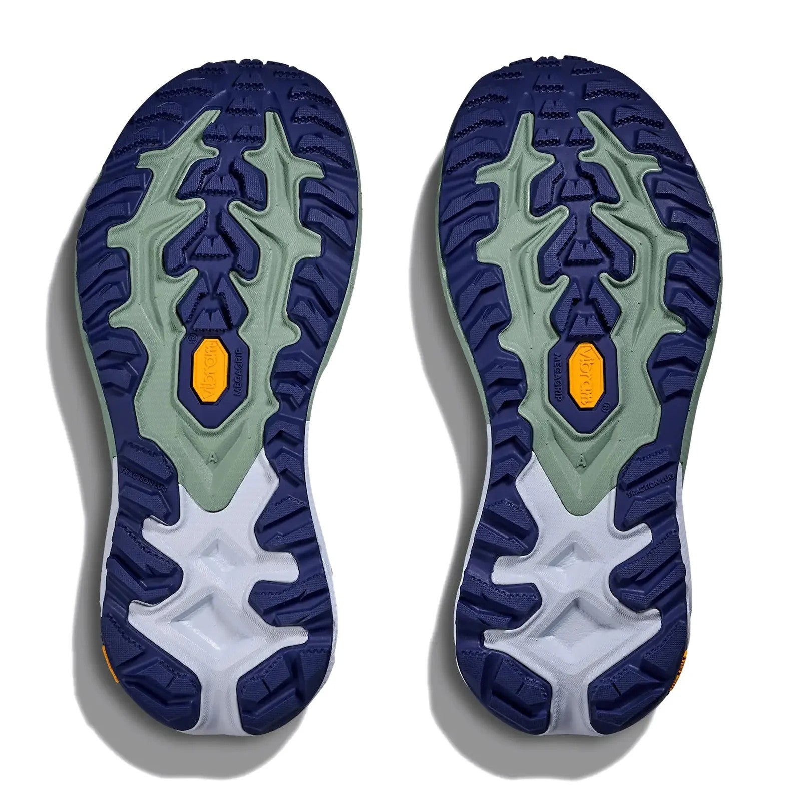 Close-up of a pair of blue and green athletic shoe soles on a white background
