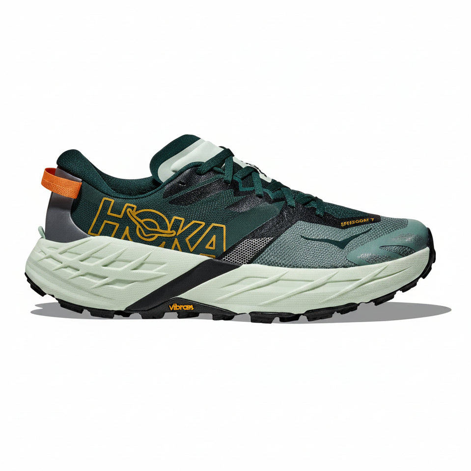 Green running shoe with orange accents on a white background