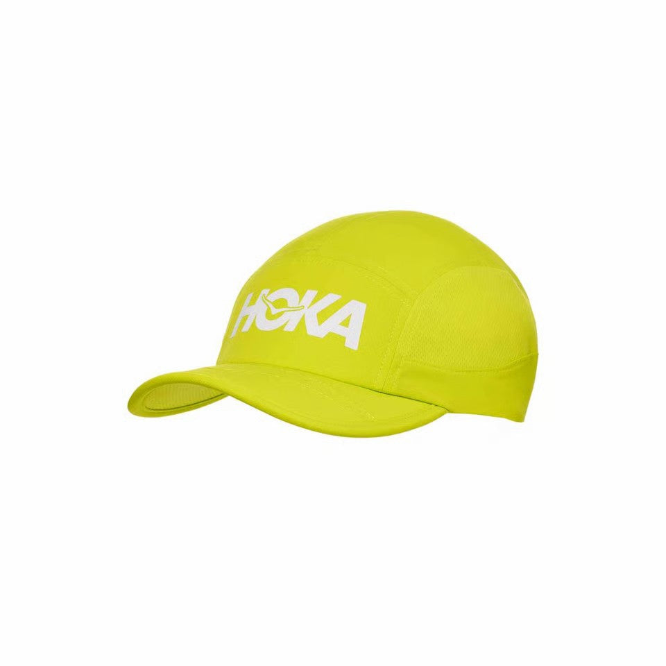 Yellow cap with 'Hoka' logo on a white background