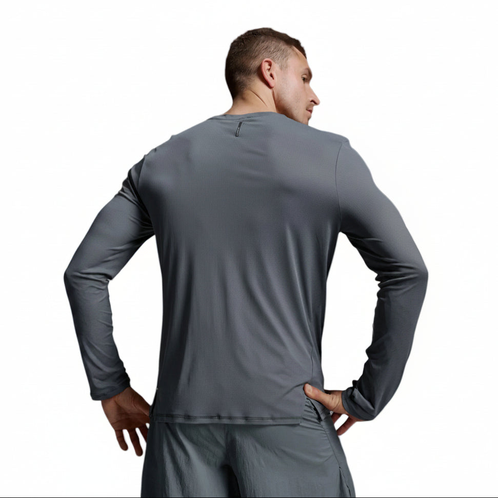 A man wearing a dark gray long-sleeve athletic shirt and matching shorts, shown from the back against a light gray studio background.
