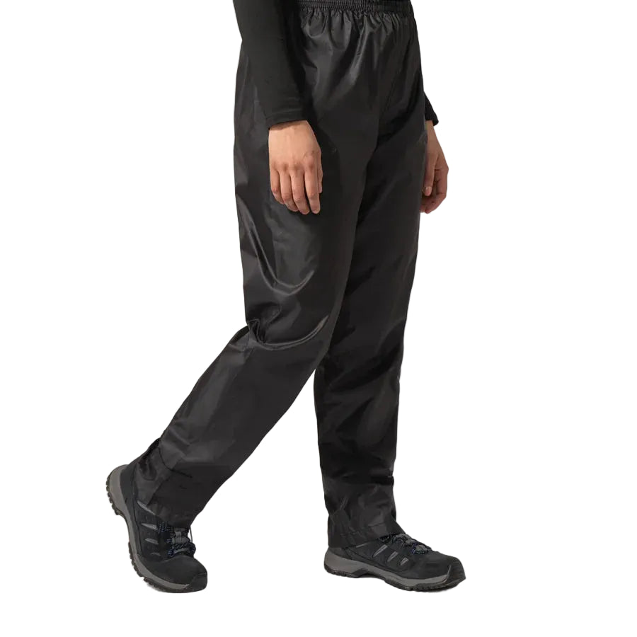 Person wearing black waterproof pants on a white background
