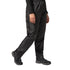Person wearing black waterproof pants on a white background