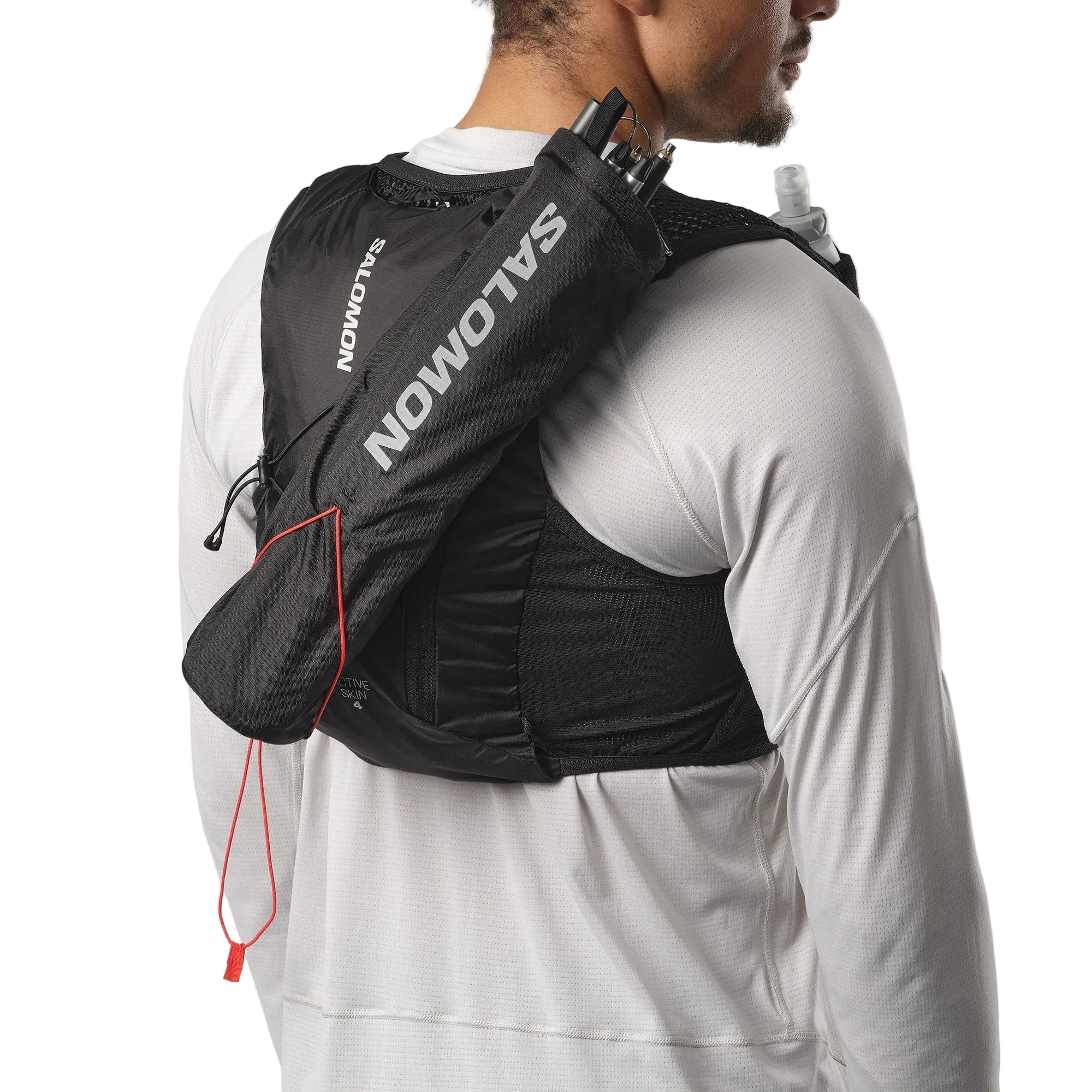 Person wearing a black Salomon hydration pack on a white background