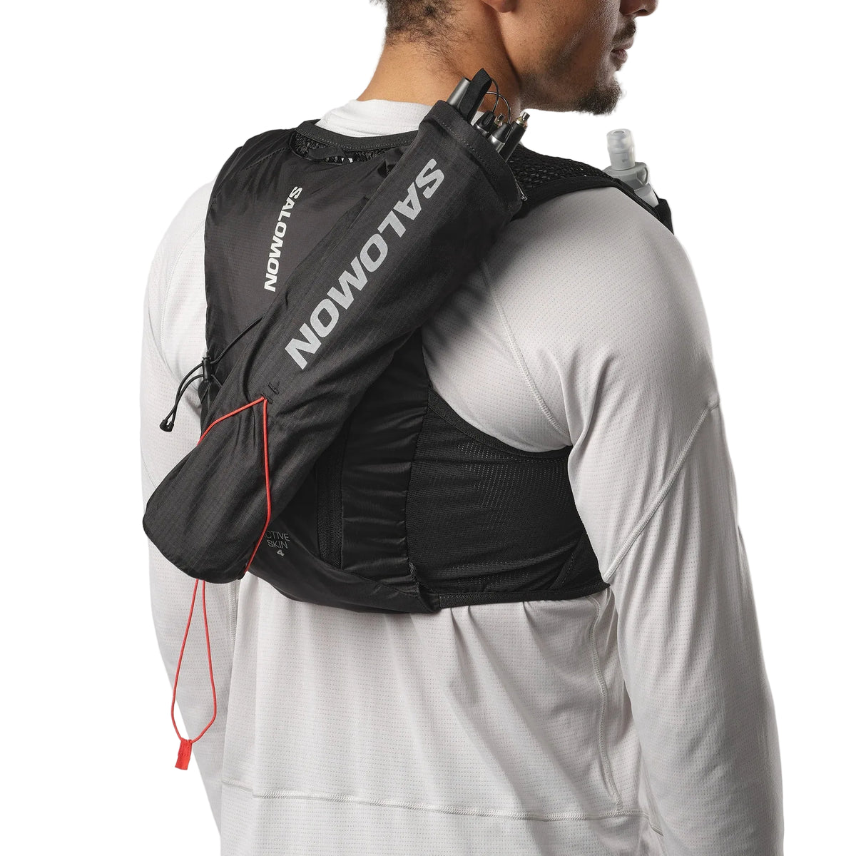 Person wearing a black Salomon hydration pack on a white background