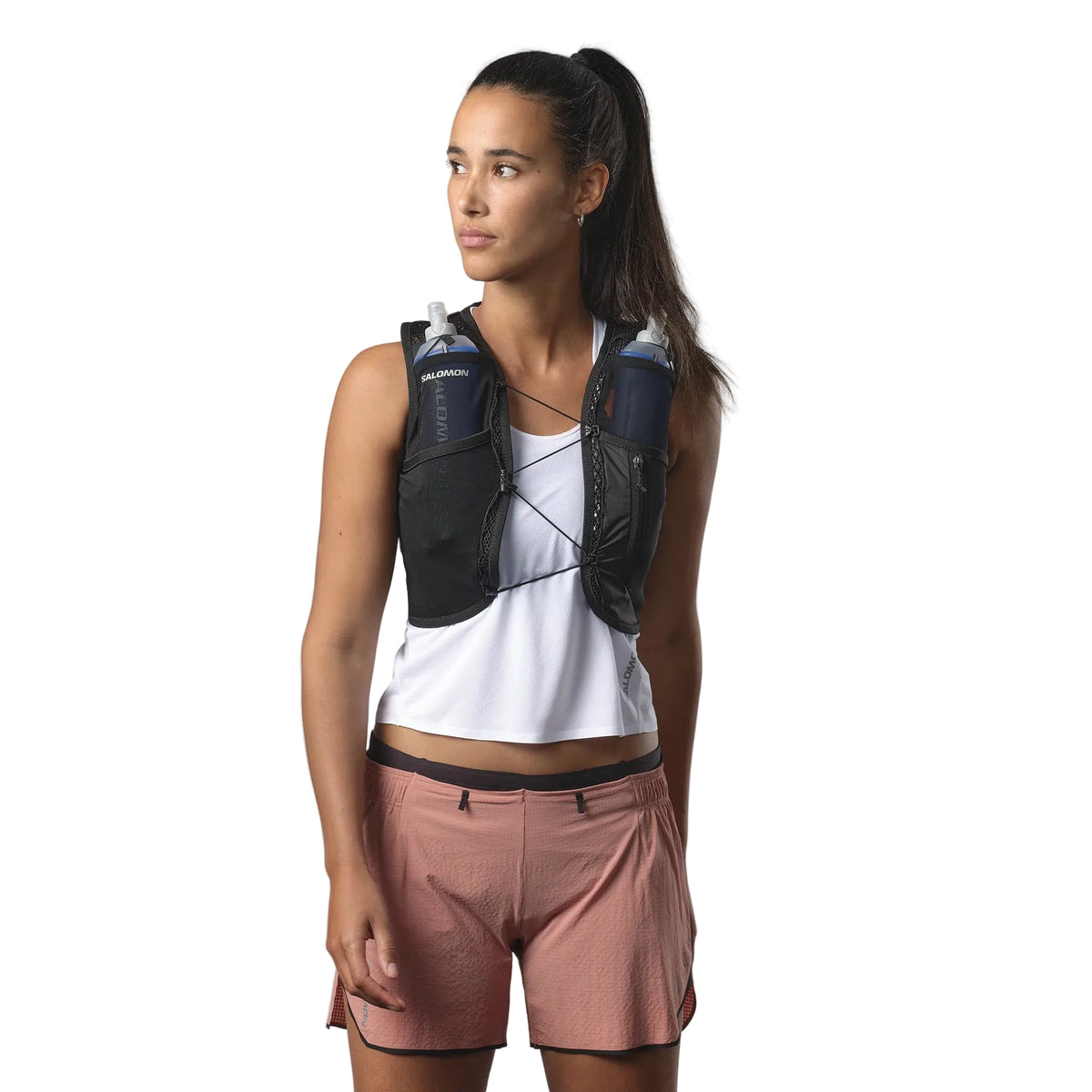 Person wearing a black hydration vest on a white background
