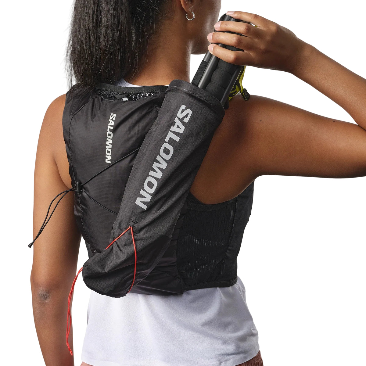 Person wearing a Salomon black hydration vest on a plain background