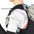 Person wearing a black and gray backpack with a white shirt featuring red accents.