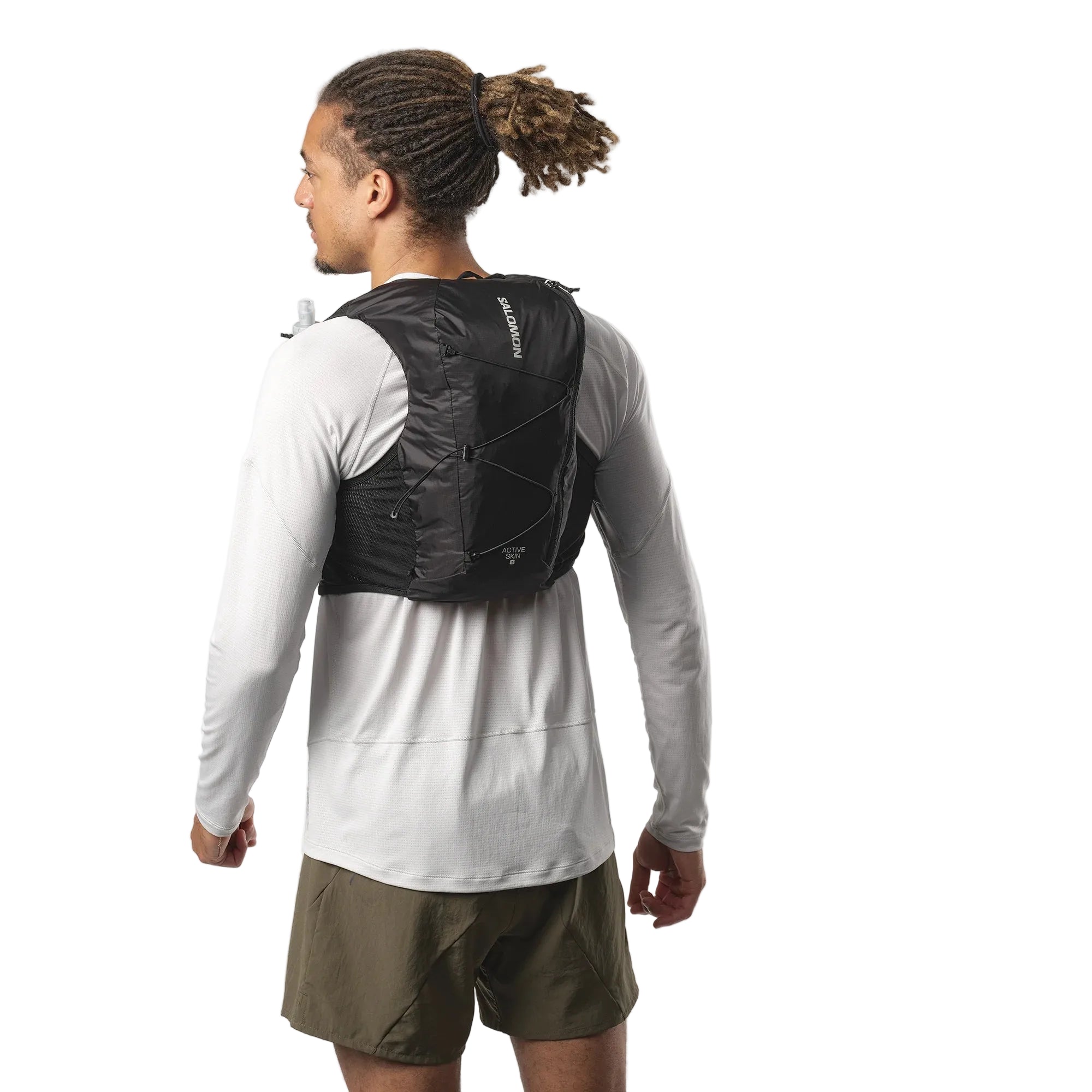 Person wearing a black hydration vest on a white background
