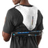 Person wearing a Salomon hydration pack with hiking poles on a plain background