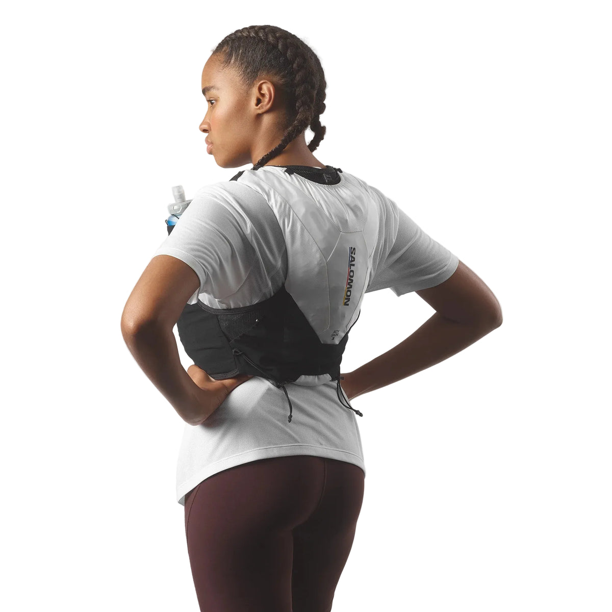 Person wearing a hydration pack on a plain background