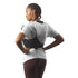 Person wearing a hydration pack on a plain background
