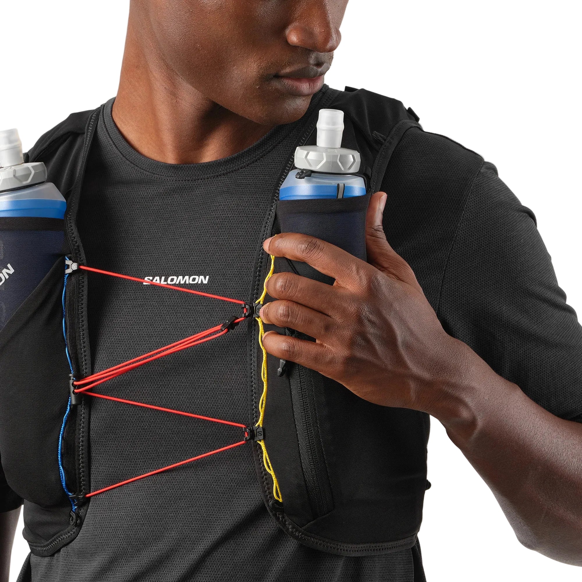 Person wearing a Salomon running vest with hydration bottles.