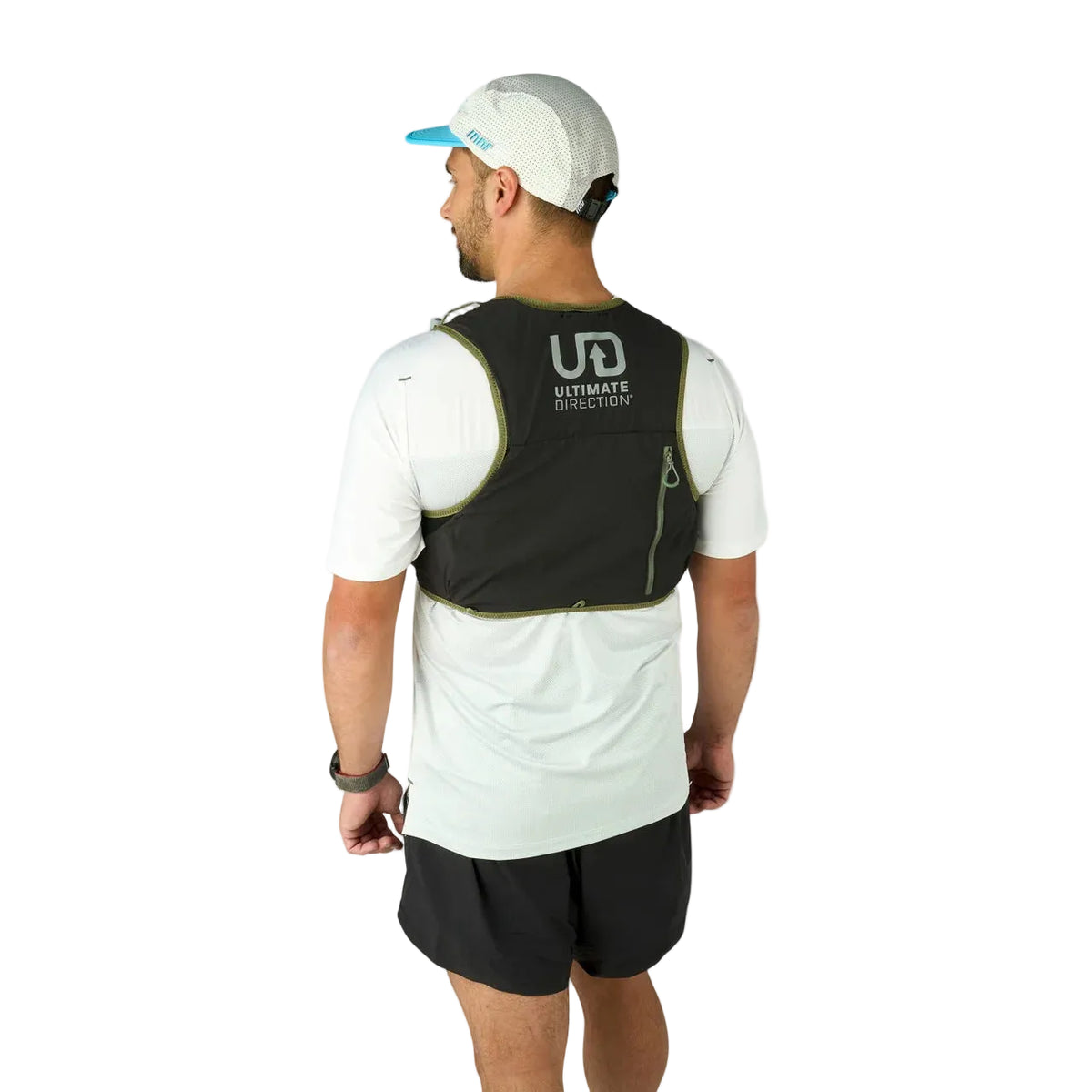 Man wearing a black running vest with 'Ultimate Direction' logo on a light gray background