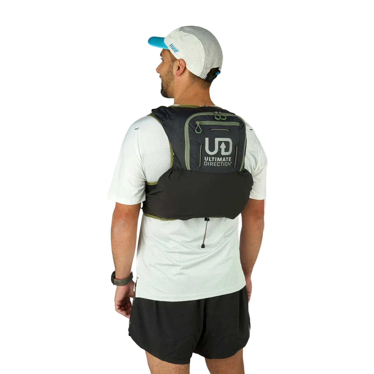 Man wearing a black running vest with 'Ultimate Direction' logo on a gray background