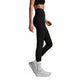 Person wearing black leggings and white sneakers on a light gray background