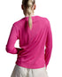 A woman viewed from behind wearing a bright pink long-sleeve athletic top and light-colored bottoms against a light gray studio background.