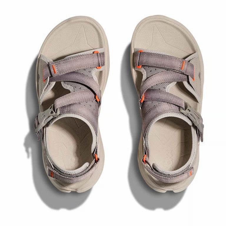 Pair of gray sandals with orange accents on a white background