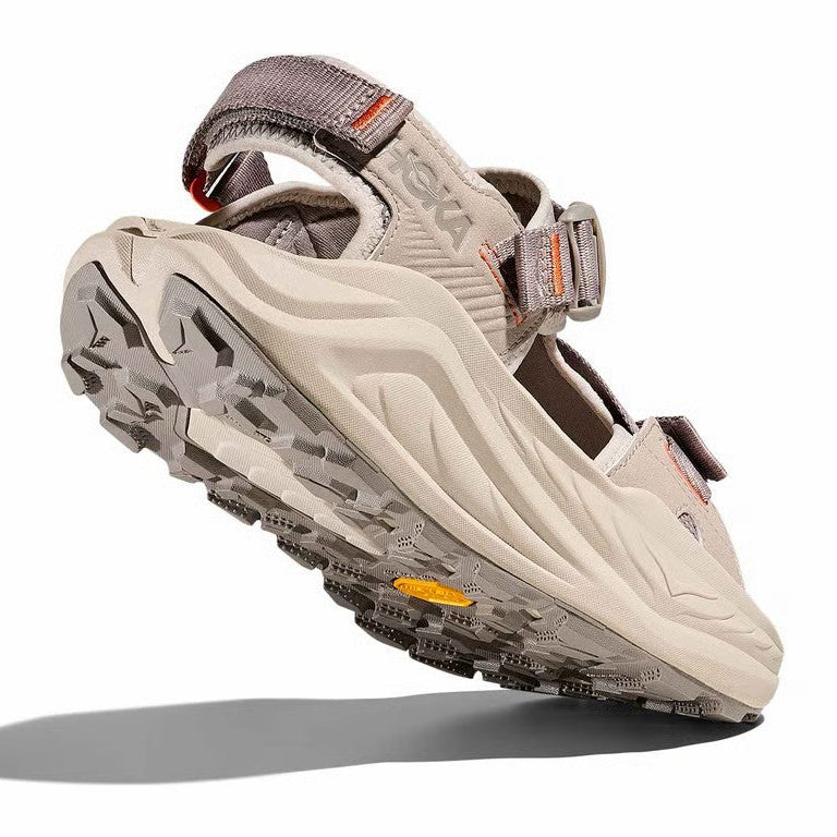Beige sandal with gray sole on a white background